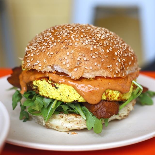 The Sunrise 🍳☀ just the breakfast sandwich you need today (it's available all day from 11am-11pm FYI) 🙌 it's made with our house-made tofu scramble, spicy merguez sausage, extra cheezy @violife_foods_usa cheddar, fresh arugula, and a sweet n tangy 
